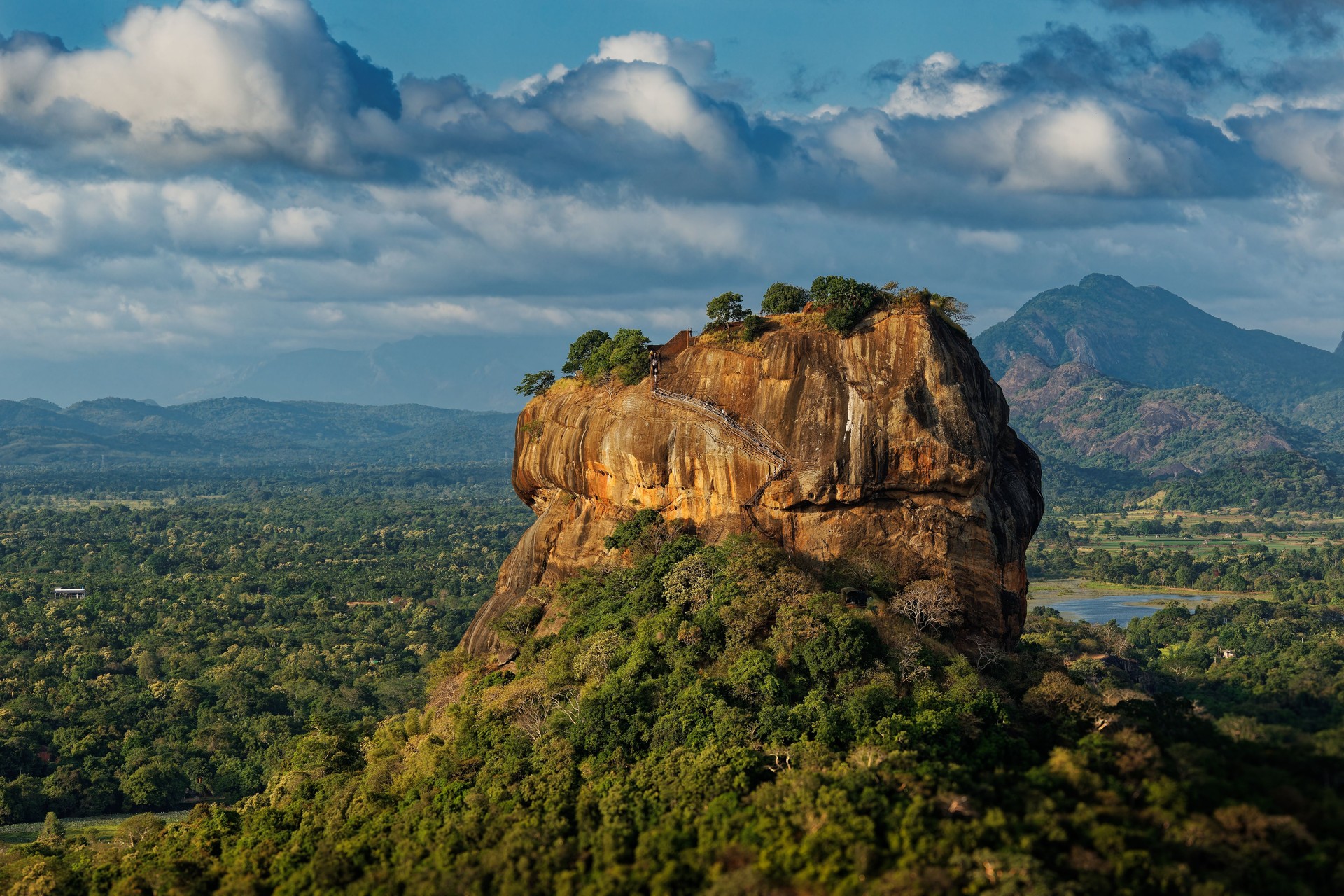 Sigiriya or Sinhagiri Lion Rock ancient rock fortress near Dambulla in Sri Lanka, historical and archaeological significance dominated by a massive column of granite, landscape view.